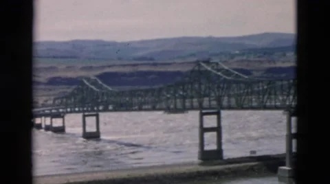 1958: bridge is seen from mountain area with greenery and trees OREGON Stock Footage