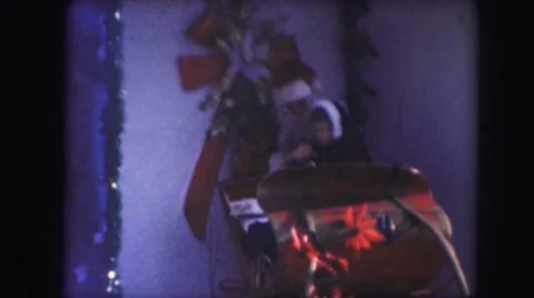 1958: a child on santa's lap in a christmas themed sleigh AMES, IOWA Stock Footage