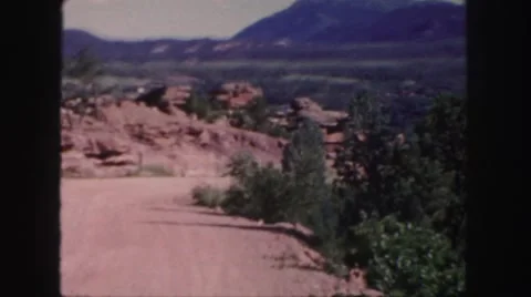 1958: couple stand upon an amazing stack of rocks under the blue sky COLORADO Stock Footage