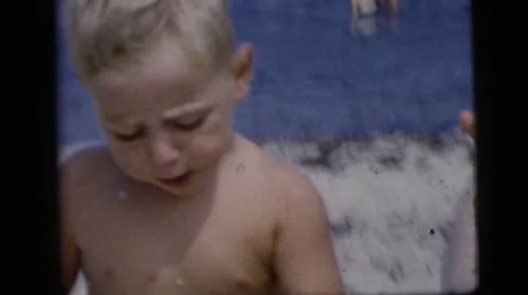 1958: a dad feeding his little boy an ice cream cone on the beach NEW YORK CITY Stock Footage