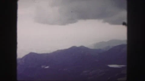 1958: huge gray cloud looming over scenic mountain range threatening storms Stock Footage