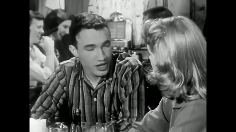 1958 - A male cousin tells his female cousin about the illness of a high school Stock Footage