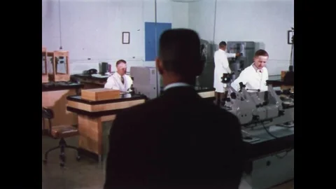 1958 - Men are seen at work in a metrology lab. Stock Footage 86407632