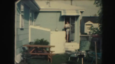 1958: a woman is seen coming out of a house AMES, IOWA Stock Footage