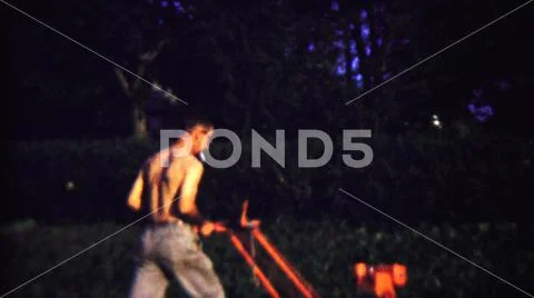 1958:SAINT FRANCIS KANSAS.A Shirtless Farmer Harvesting Crop Using A