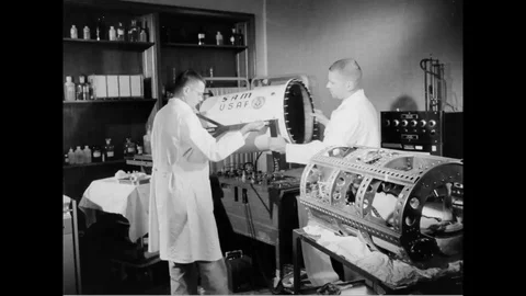 1959 - Aerospace engineers prepare a School of Aviation Medicine capsule at Stock Footage 126072694