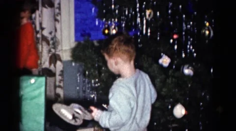 1959: a christmas tree is seen with a child opening presents CATSKILL GAME FARM Stock Footage