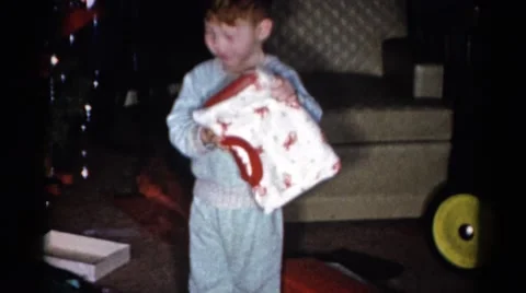 1959: a christmas tree is seen with a child opening presents CATSKILL GAME FARM Stock Footage
