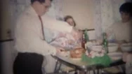 1959: Dad Slices Holiday Ham For Family At Modest Diner Table. Buffalo, New York Stock Footage