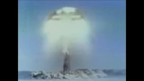 1959 - Scientific processes as the mushroom cloud of a nuclear bomb expands. Stock Footage 84046472