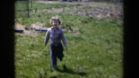 1959: Small Child Running to Camera and Petting Dog NEW YORK Stock Footage 70539651