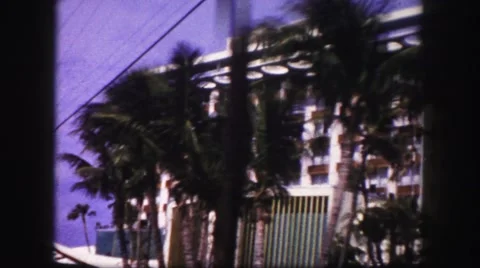 1960: driving past nice hotel with palm trees in the front FLORIDA Stock Footage