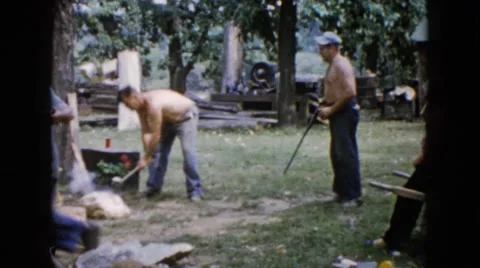 1960: man pretends to shoot rifle at laborer Stock Footage