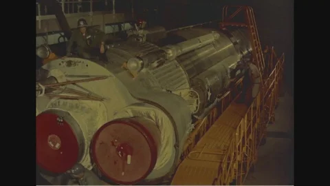 1960 - Technicians are seen working on an Atlas rocket in a maintenance building Vídeos de archivo 129054314
