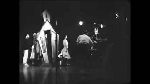 1960 - A TV director oversees a camera rehearsal for a musical program from his Stock Footage 155857962