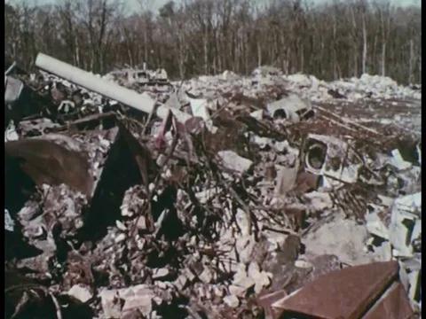 1960s _ Bulldozers move and compact trash at a poorly run landfill. Stock Footage