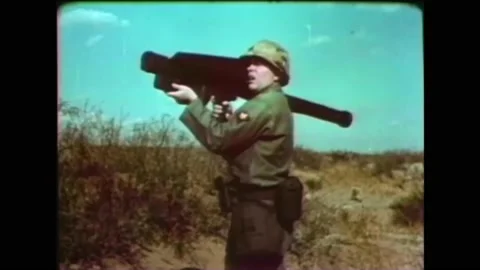 1960s - An American soldier practices using a flamethrower while another uses a Stock Footage 152507434