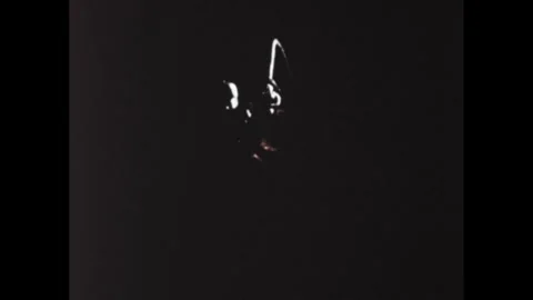 1960s: Animation, man in spacesuit with flashlight, pan to man in space suit. Stock Footage 307513864