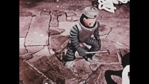 1960s: Animation, man in spacesuit hitting rocks with hammer. Image on screen, Stock Footage 307513795