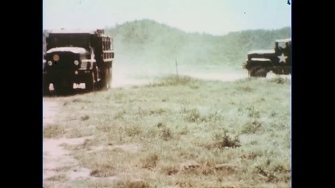 1960s: Army trucks filled with soldiers pull up and stop. Stock Footage