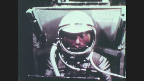 1960s: Astronaut operates machine. Machine rotates. Two children play. One kid Stock Footage