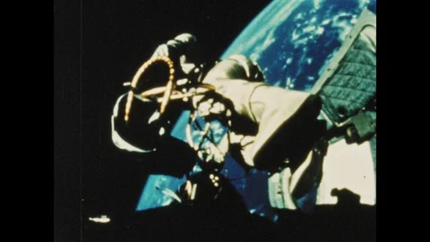 1960s: Astronaut in space suit performs spacewalk on Gemini craft. Stock Footage 101665587
