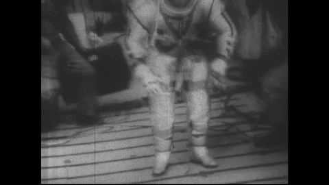 1960s: Astronaut in space suit trains in moon gravity simulator. Stock Footage