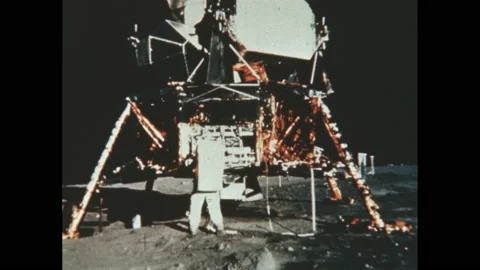 1960s: Astronaut takes soil sample from lunar surface. Astronauts carry cases Video stock 192246653
