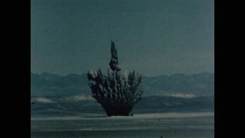 1960s: Atomic bomb explodes in desert. Radiation cloud rises in air in all 스톡 동영상 159176620