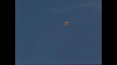 1960s: Balloon with string and item attached float away in sky. Stock Footage 277654576