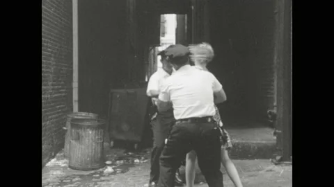 1960s Baltimore: Police chase and apprehend teenage girl in alley.  Men escort Stock Footage