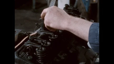 1960s: Bolts in the engine being tightened with a torque wrench. 库存影片 244537693
