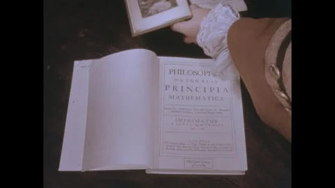 1960s: Books open on table, hand picks up book, flips through pages. Stock Footage 246884562