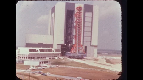 1960s: Building.  Rocket on launch pad.  Parking lot.  Truck drives down road. Vídeos de archivo 113944503