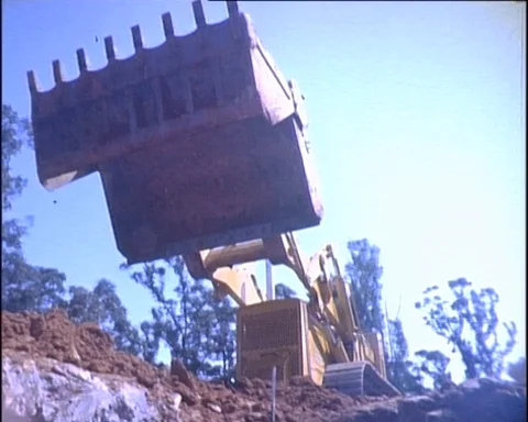 1960s: Bulldozer Movers Over Camera  Stock Footage 99862641