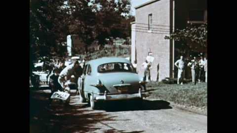1960s: Car pulls up to picket line. Men open car doors and drag passengers out. Stock Footage 163653169