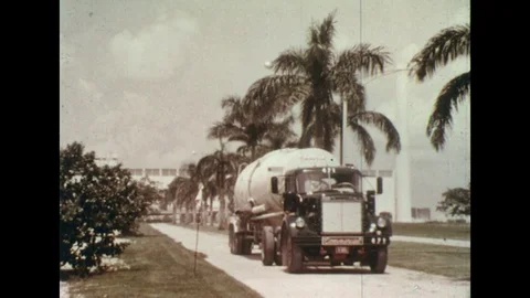 1960s: Cement truck driving from factory / Interior of cement plant. Stock Footage