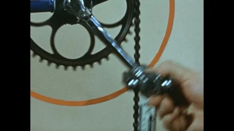 1960s: Chain on bicycle wheel. Meter with measurements, needle points at 10. 스톡 동영상 280052471