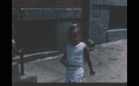 1960s: Child walks down sidewalk, stands by steps. Children hang out outside. Stock Footage 146598152