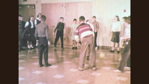 1960s: Children play dodgeball indoors.  Homes.  Church.  School buildings. Stock Footage