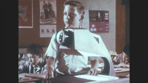 1960s: Classroom.  Boy stands at overhead projector and reads.  List of Stock Footage 91233314