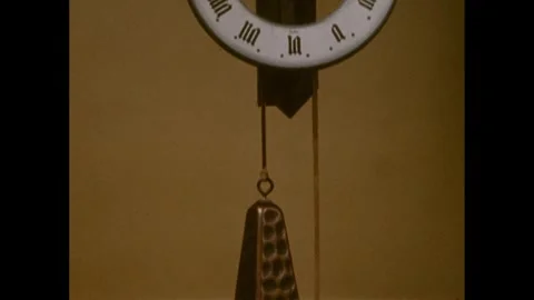 1960s: Clock.  Pendulum. Stock Footage 248557664