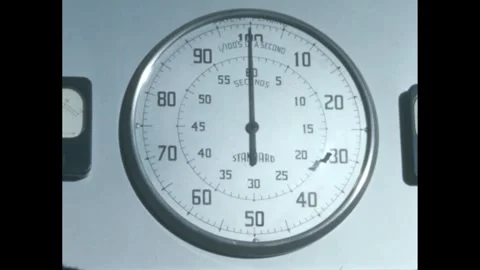 1960s: Clock on wall. Swimmers dive into swimming pool in competition. 스톡 동영상 273495962