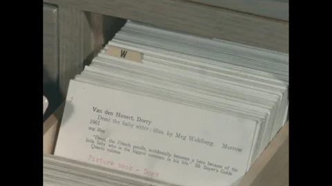 1960s: Close up, hand flipping through card catalog. Stock-Footage 295290069
