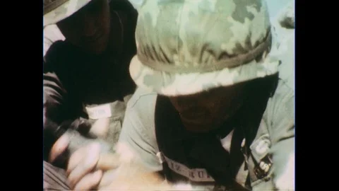 1960s: Close up, soldier presses detonator / Explosion / Close up, officer bites Stock Footage