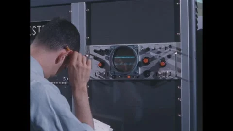 1960s: Computer.  Man turns knob.  Lines on monitor.  Man makes note.  Shooting Video stock 278921081