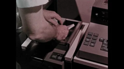 1960s: Computer punch card of data. Stack of punch cards are fed into computer. Stock Footage 264967859