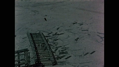 1960s: Debris of structure sprawling across desert. Trucks parked across desert Stock Footage 159174989