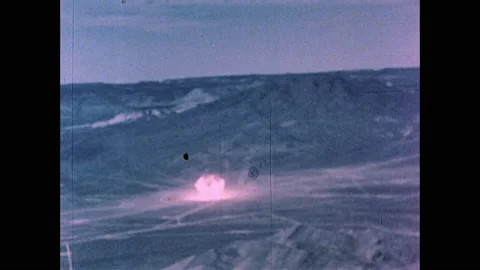 1960s: Desert, atomic bomb explodes, radiation cloud rises into sky in all 스톡 동영상 159489713