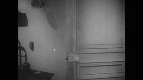 1960s: Door opens, men walk into room. Man sets down luggage, speaks. Porter Stock Footage 123021511